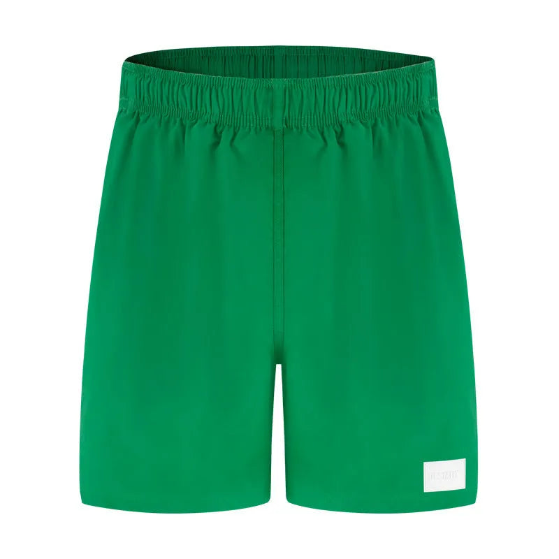 Men's quick-dry nylon swim shorts in solid colours with straight leg opening