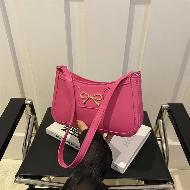 Portable PU shoulder bag in western baguette style with bow detail, 24x14x5 cm, available in multiple colours