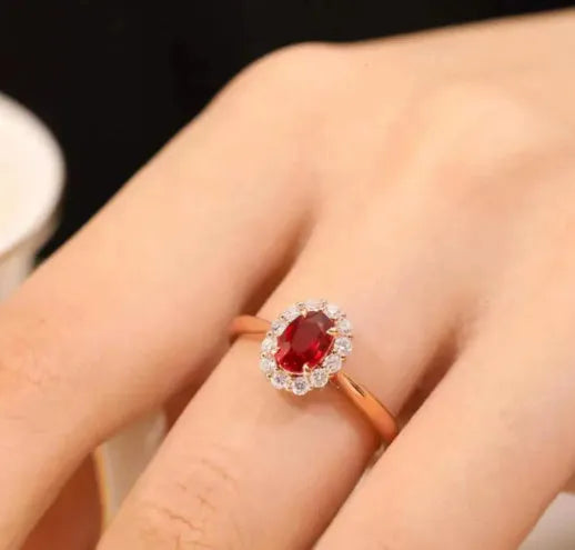 Gold Pigeon red blood gemstone silver-plated ring with floral design on white background