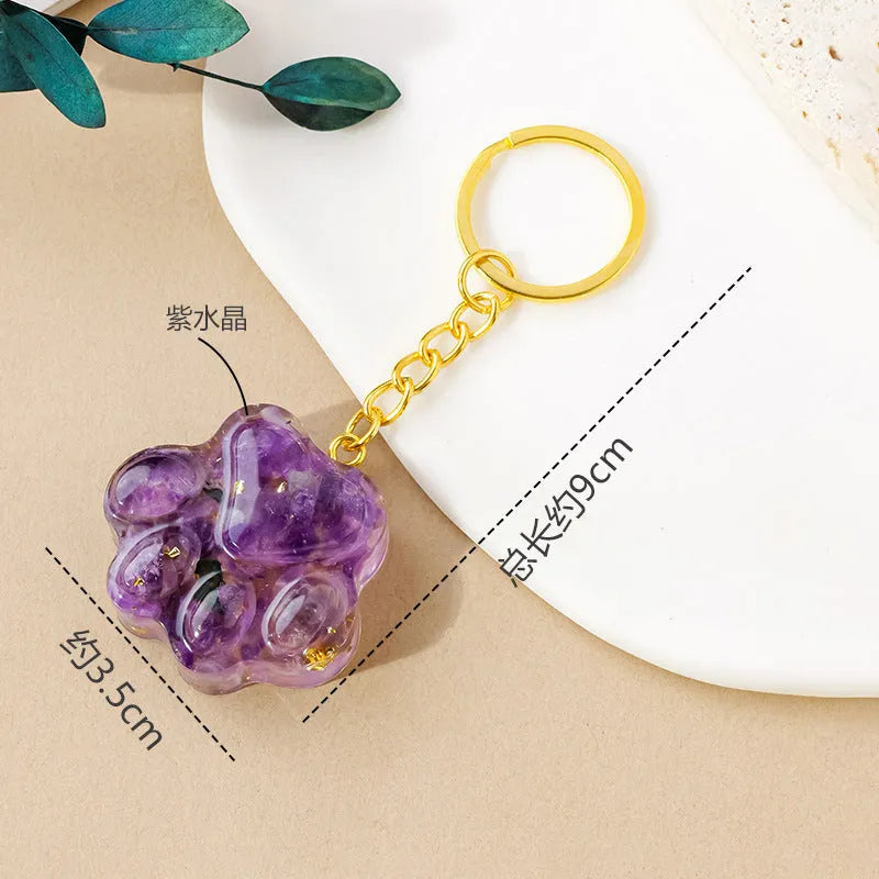 Natural crystal cat's paw keychain pendant in various gemstone colours including pink, red, green and blue variants