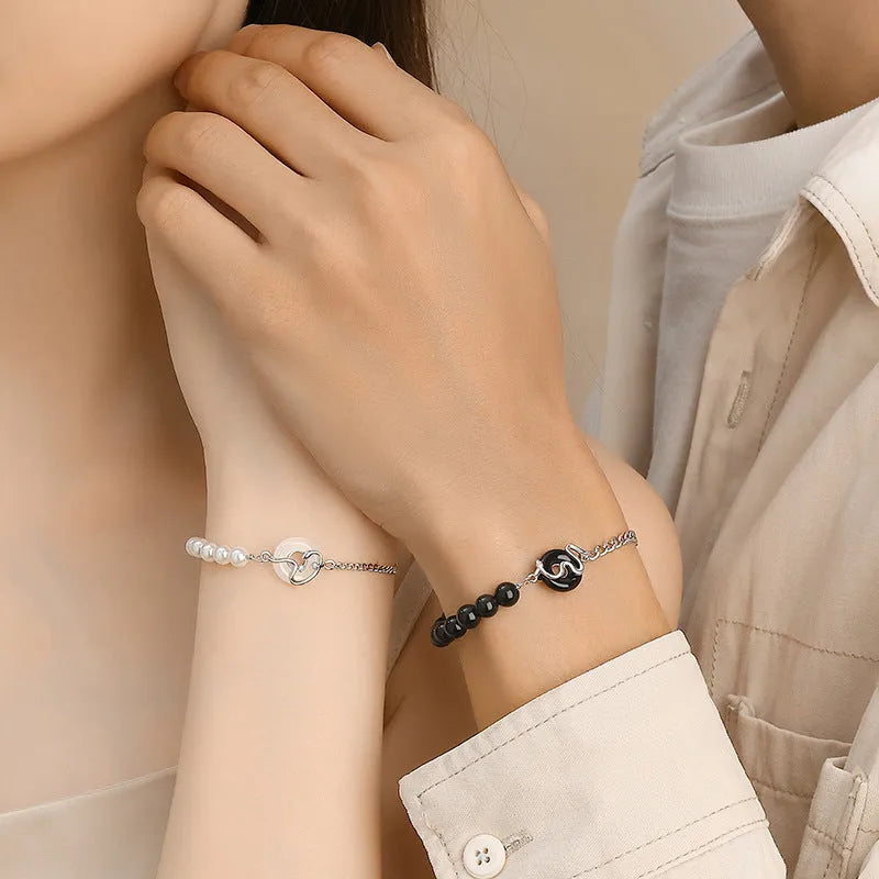 A New Chinese style 925 sterling silver couple bracelet with an obsidian pearl and snake zodiac motif on a secure buckle.