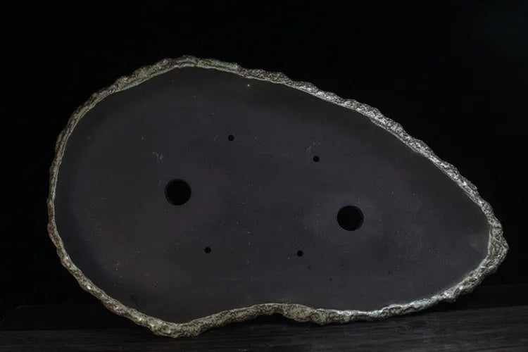 Handmade purple clay flower pot for indoor plants with unique shape and drainage holes