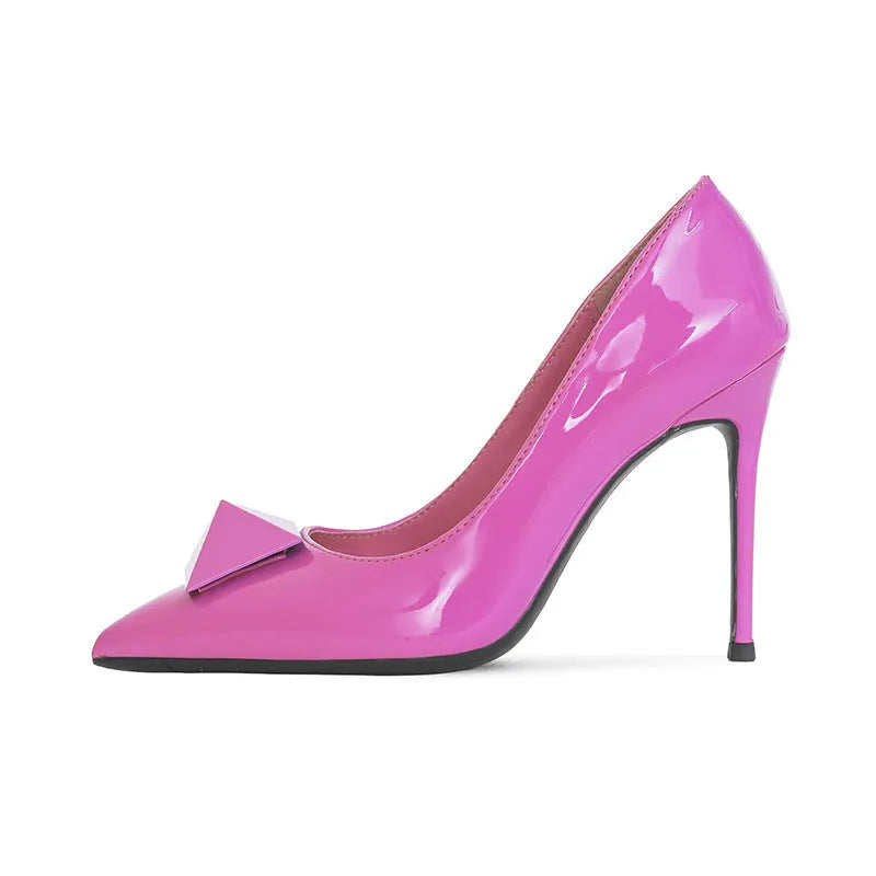 Pink women's patent leather pointed toe stiletto high heels with a buckle, on a white background.