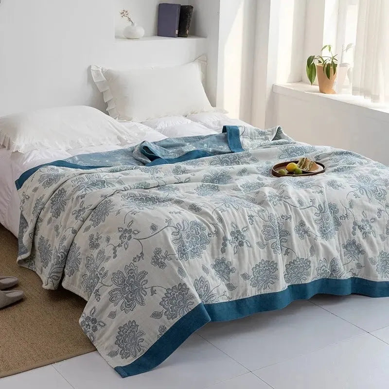 Pure cotton five-layer gauze bed sheet blanket in Roulette Wheel Blue pattern, shown on a bed.