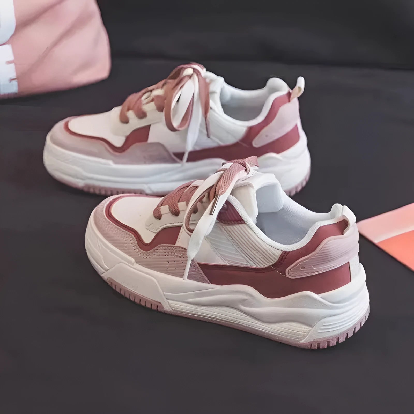 Beige and pink low-top sneaker with a height-increasing rubber sole on a white background