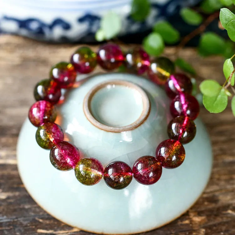 Handmade watermelon crystal bracelet for women showing pastoral design on a wrist.
