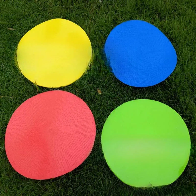 Flat circular yellow football training landmark pad on grass, 23cm diameter