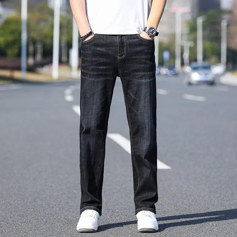 Thin stretch cotton denim trousers in black, tapered business casual style with belt loops and front pockets