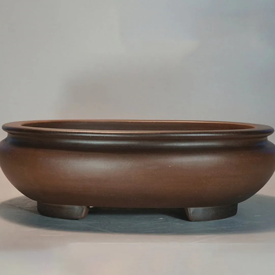 Handmade classical purple clay flowerpot for indoor desktop use.