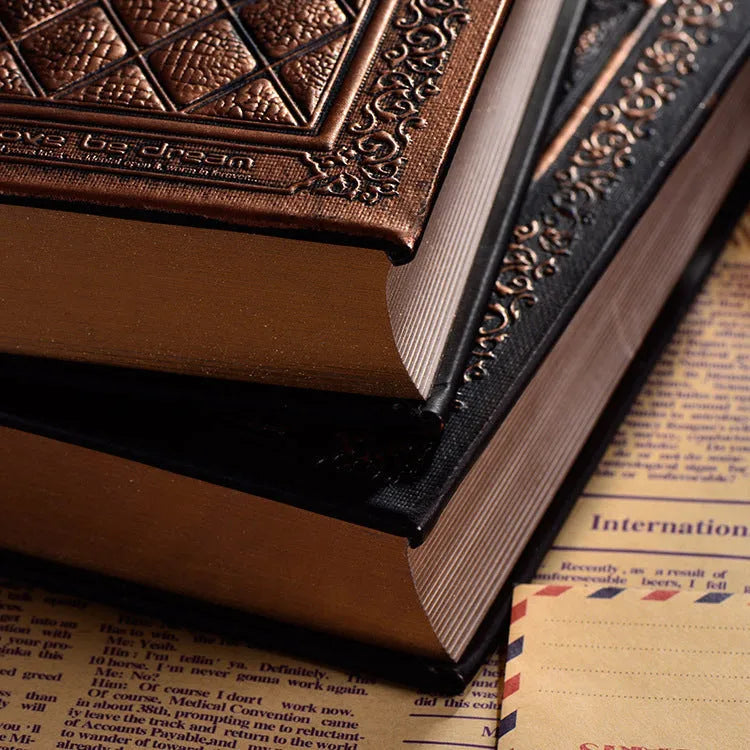 Embossed faux leather notepad showing three-dimensional geometric pattern in bronze colour with thick paper pages