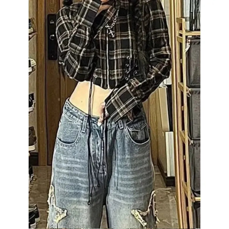 Blue high-waisted wide-leg women's denim trousers on a hanger.