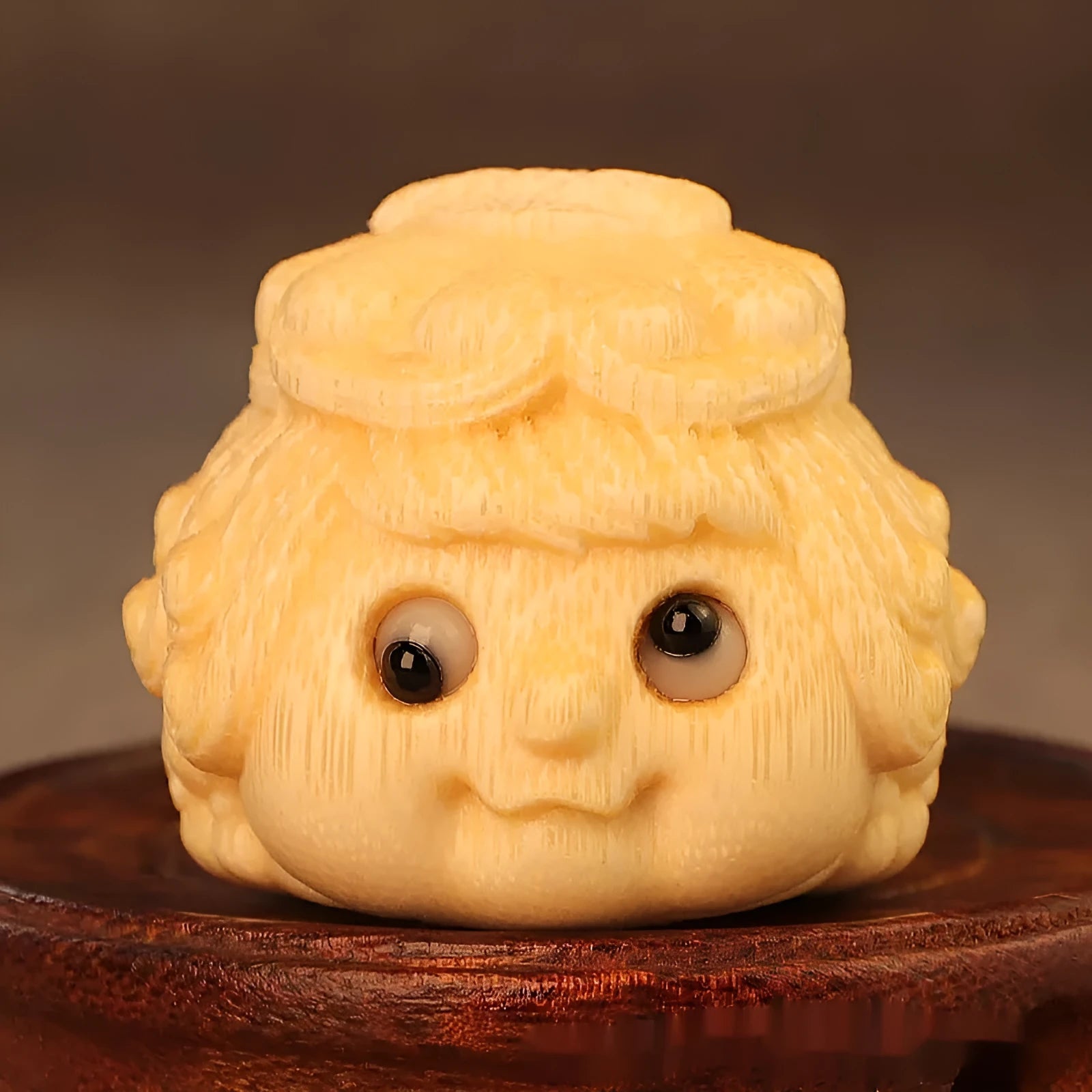 Solid bamboo carving of a cute Golden Toad Princess ornament on a white background.