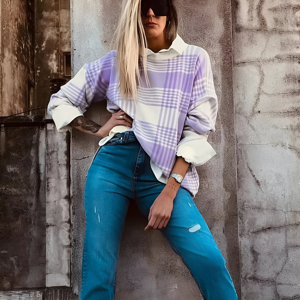 Lilac plaid print loose sweater with ribbed trim and long sleeves on a hanger