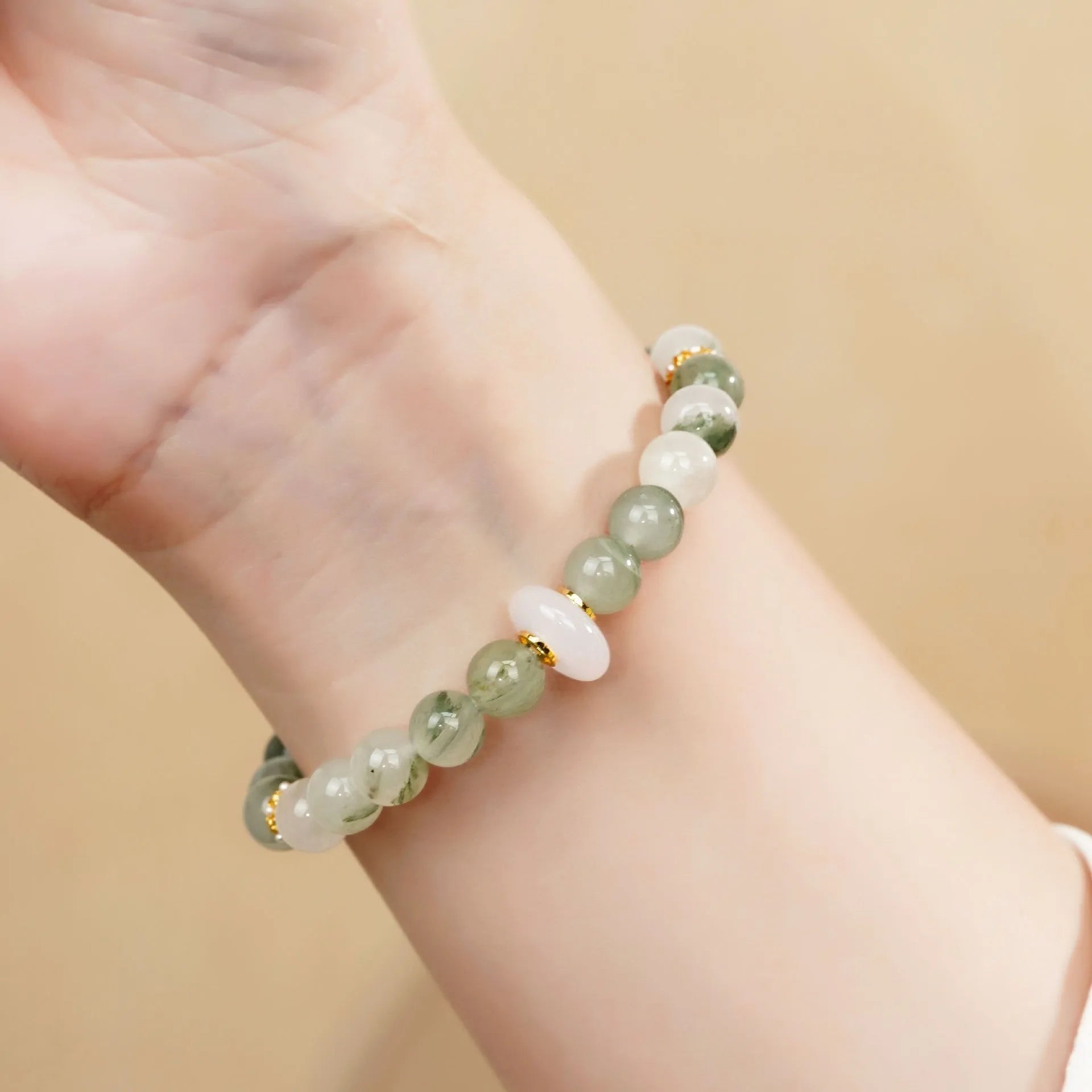 Light green emerald Tian Shan Cui half bracelet with floating flower girl motif on white background