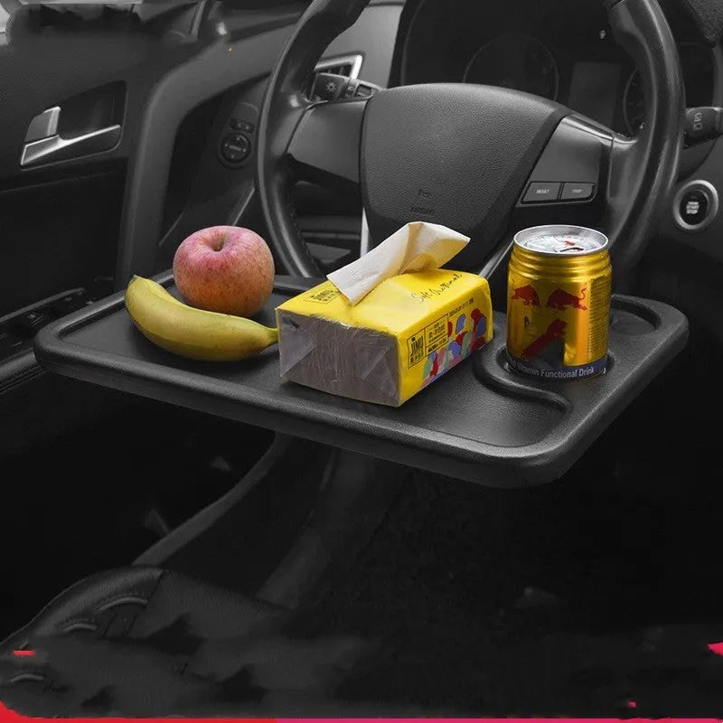 Black plastic car computer desk and dining tray measuring 42 x 28cm on a car seat