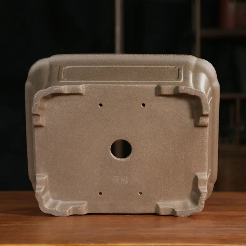 Rectangular antique purple sand bonsai pot on floor, showing Old Segment Mud textured finish.