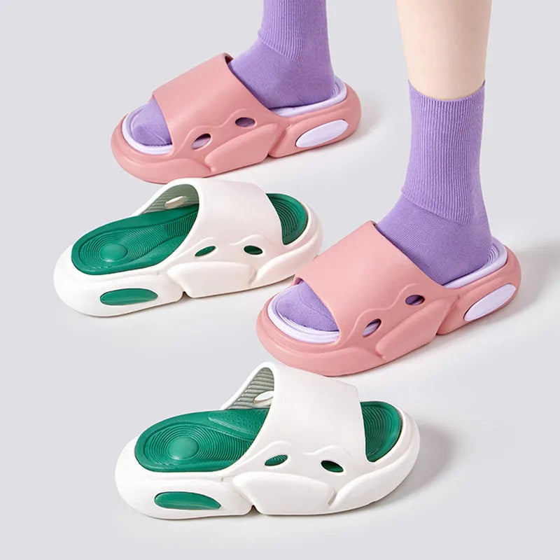 Two-colour couple slippers showing thick EVA sole and round toe, displayed in black and white colourway.