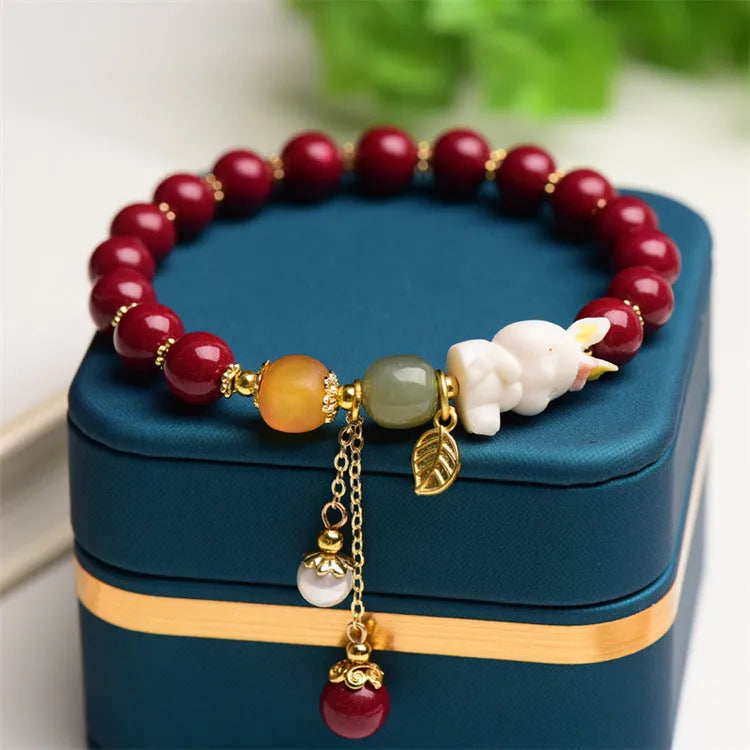 Natural cinnabar rabbit charm bracelet in Chinese national style, available in 8mm or 10mm diameters