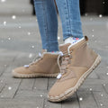 Outdoor snow boots with lace-up front, round toe, and black rubber sole shown in khaki colour.