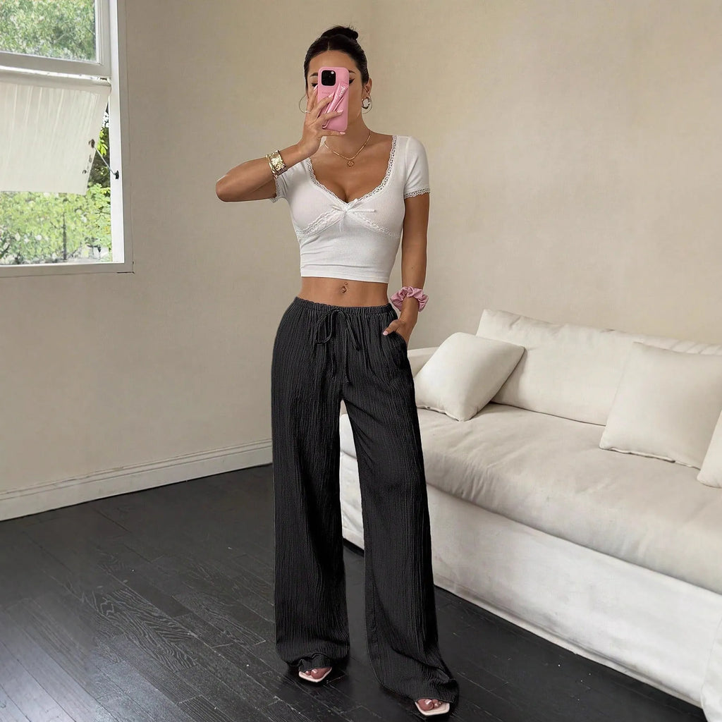 Women's black wide-leg trousers with lace-up waist trimming detail on mid waist