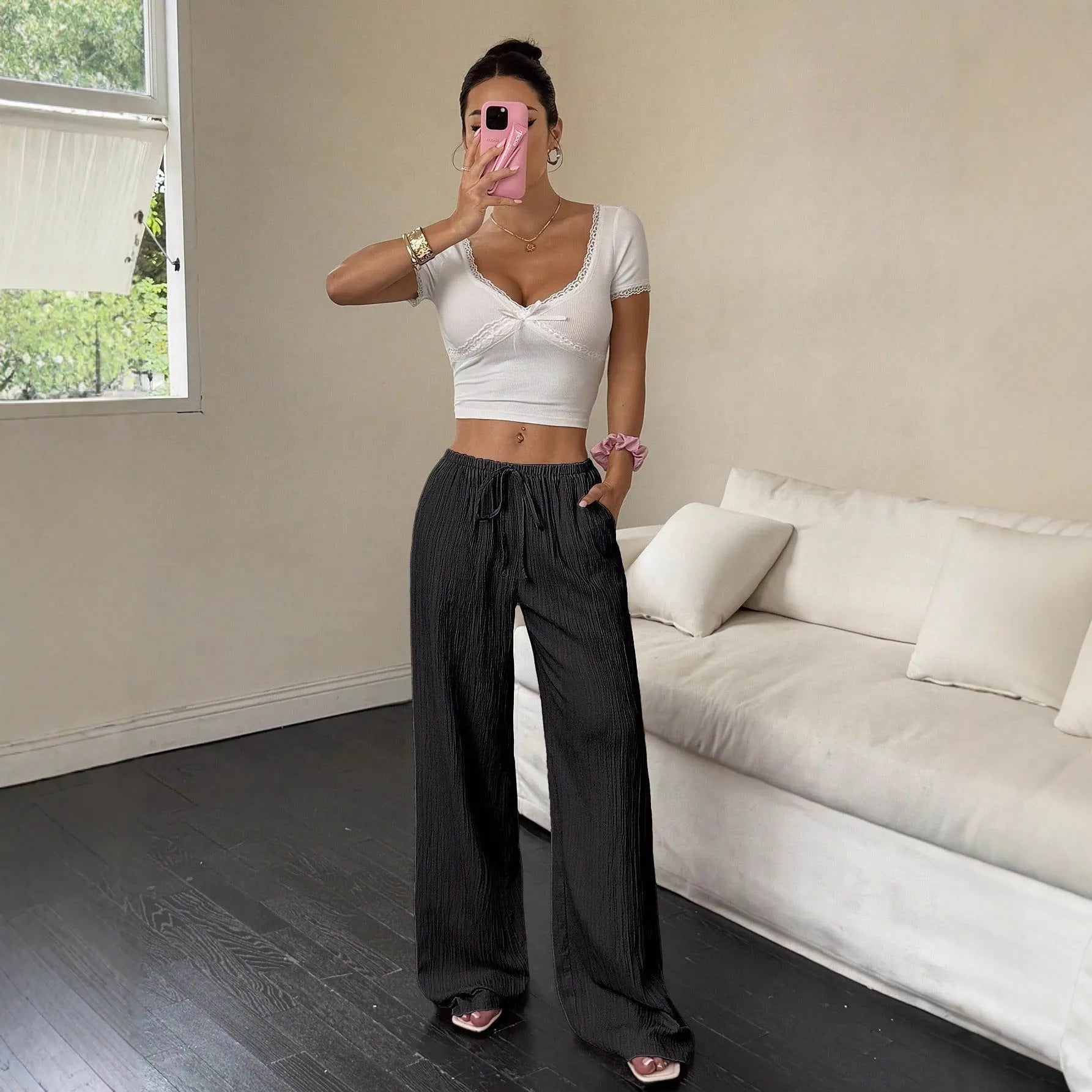Women's black wide-leg trousers with lace-up waist trimming detail on mid waist