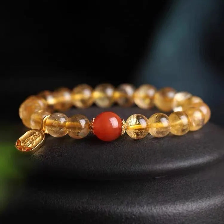 Natural red agate bracelet with gold ruby beads on a light background, polished finish, 8mm size