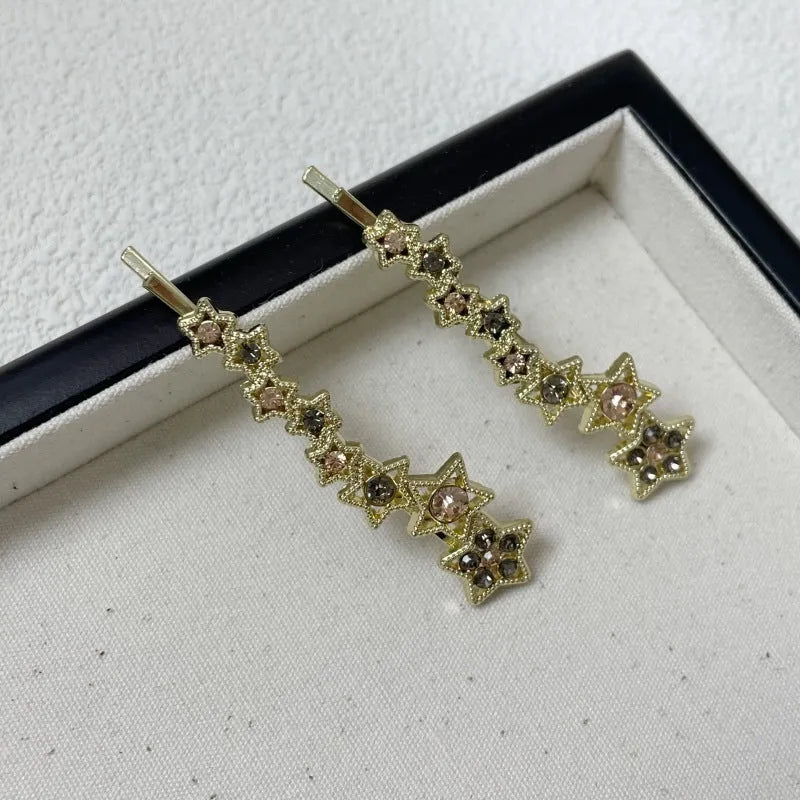 Gold colour alloy hair barrettes with broken clip design and five-pointed star decoration