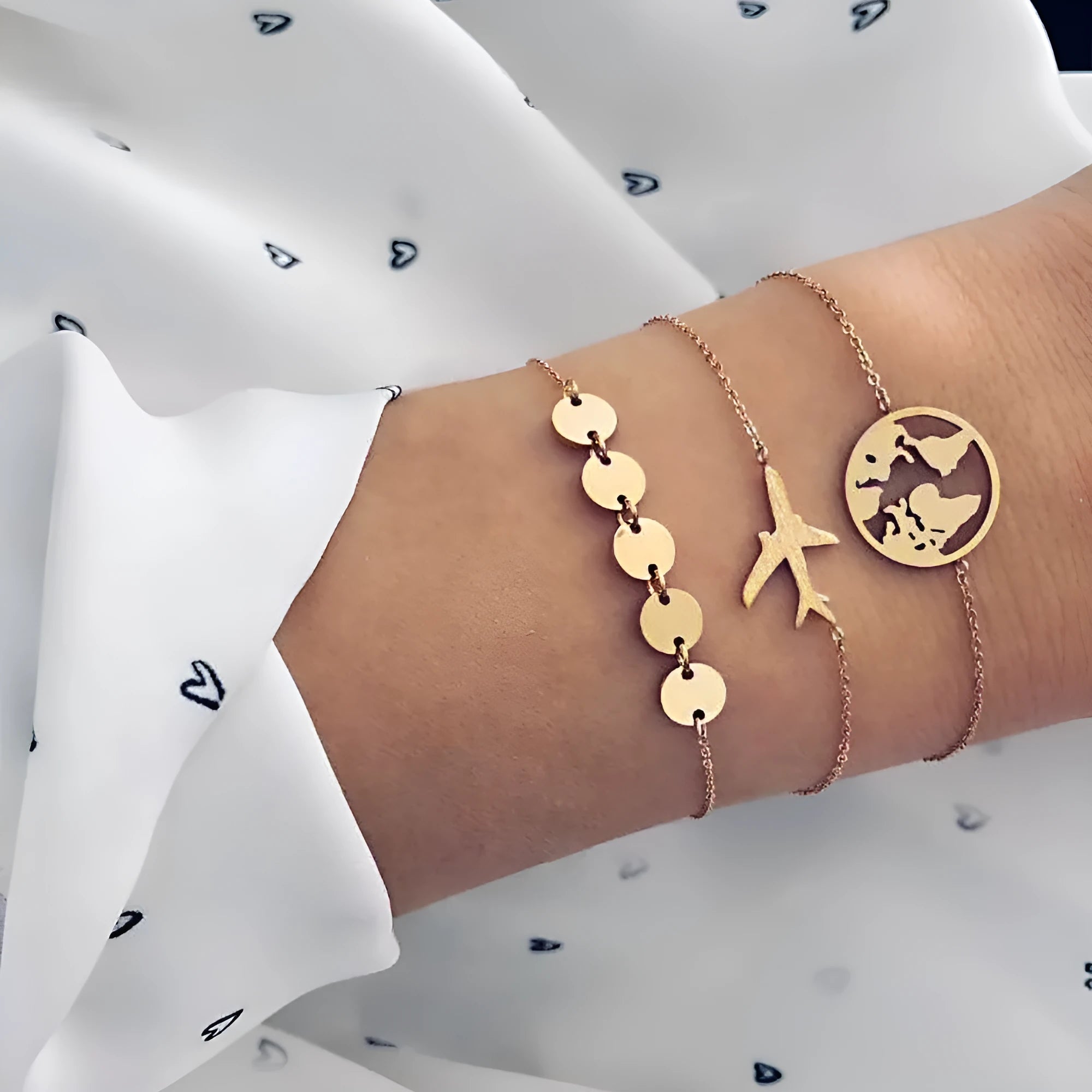 Three identical women's alloy charm bracelets with heart-shaped aircraft map charm on a white background.