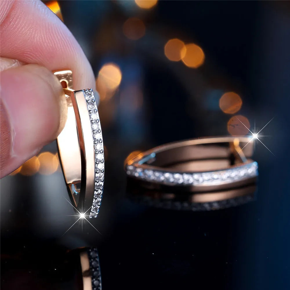 Women's V-shaped geometric copper ear clips in champagne gold with white diamond accents