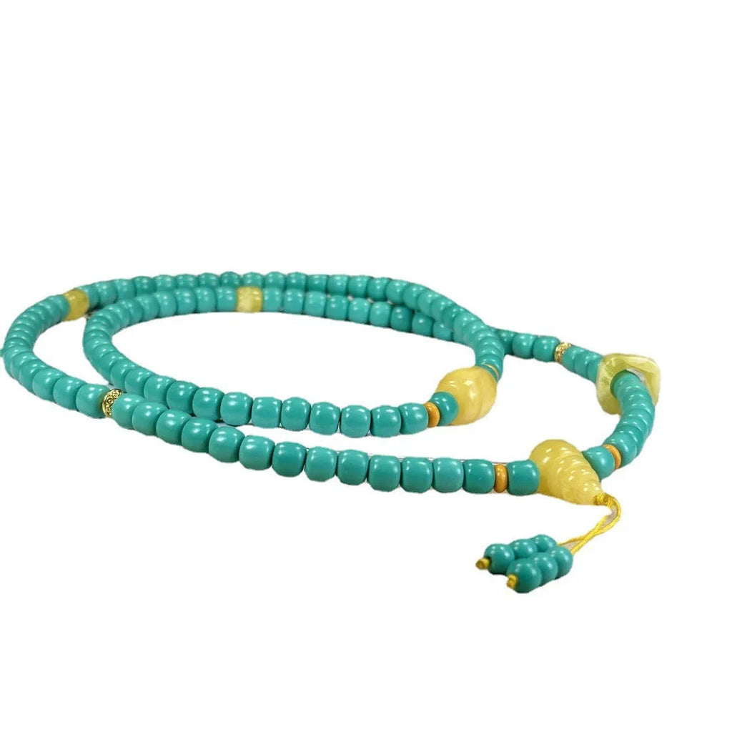 Turquoise lucky pendant necklace with hand-woven mesh flower design on an adjustable ball bead chain.