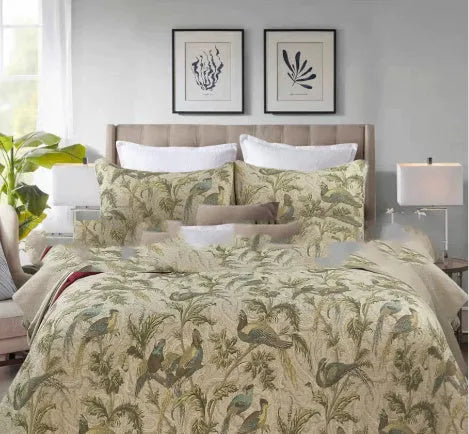 Blue American floral and bird pattern on a pure cotton quilt set with pillowcases, laid on a bed.