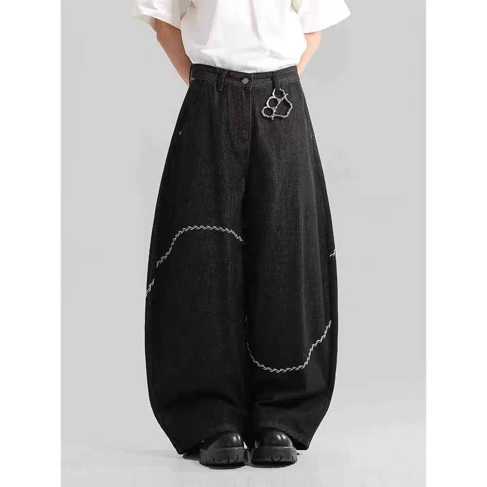 Black straight-leg denim trousers with mid waist and zip placket closure on hanger