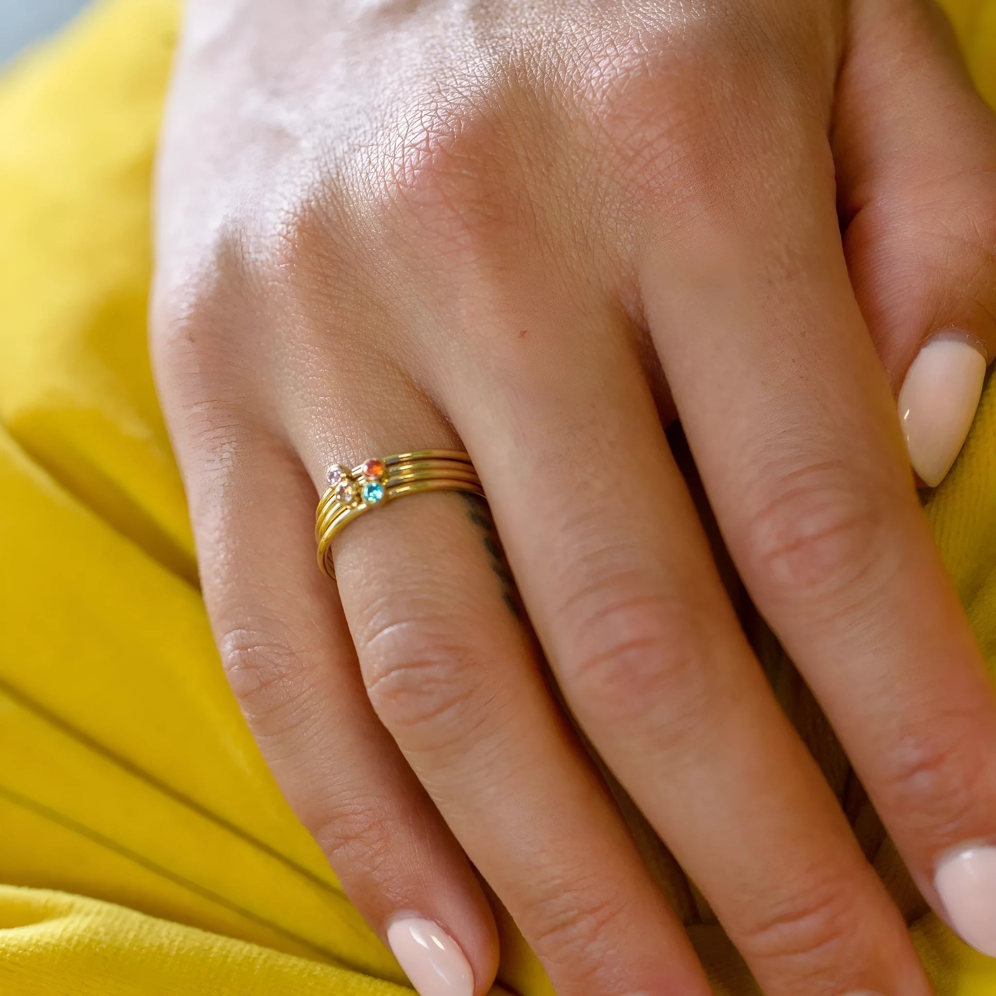 Geometric titanium steel ring with engraved December birthstone colour design on a white background.