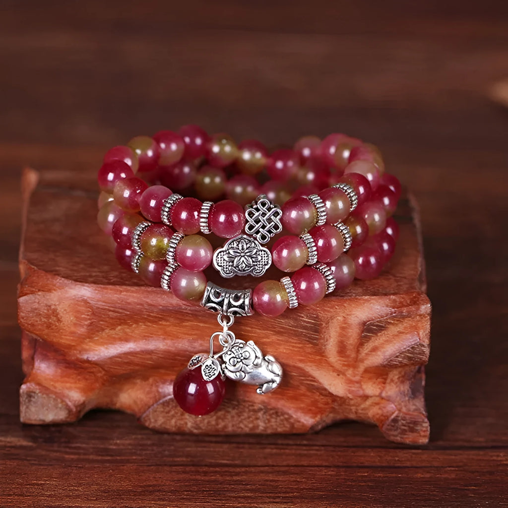 Handmade bracelet with geometric watermelon crystal beads and Chinese knotting in 6mm or 8mm size.