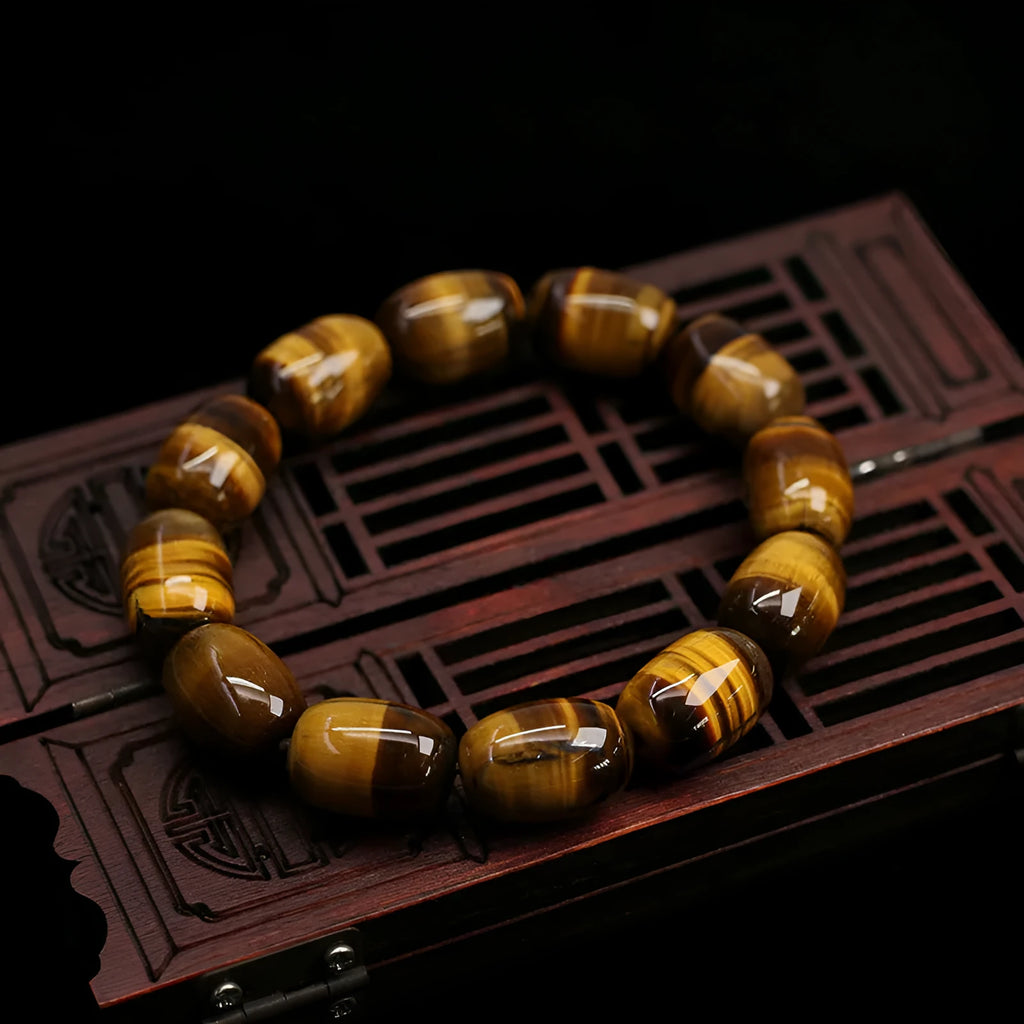 Natural yellow tigereye bracelet with cat eye sheen, 11x16mm beads, unisex constellation style on white background