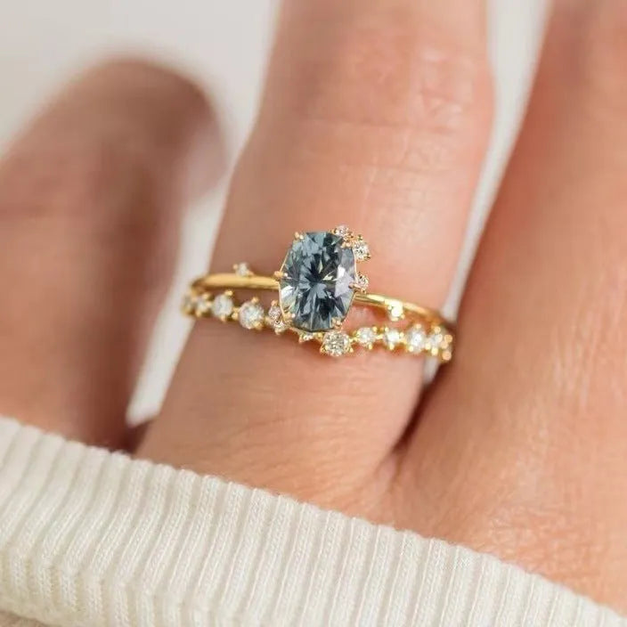Gold electroplated flower-shaped alloy ring with a central green zircon stone.