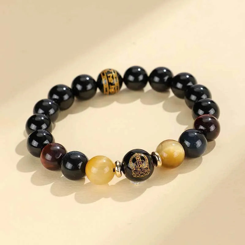 Black agate beaded bracelet with tiger eye stones in ethnic style on plain background