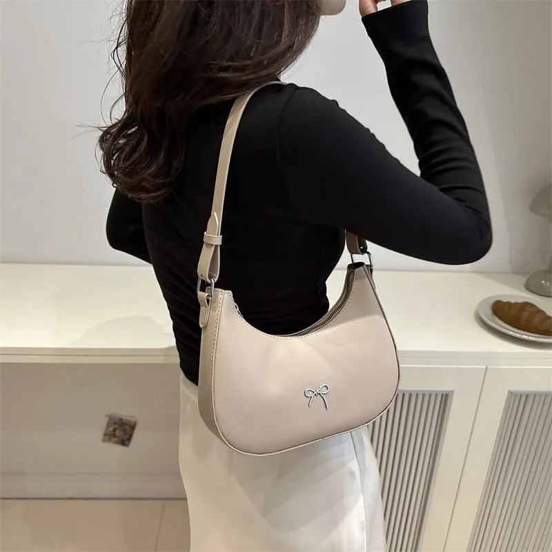 Women's underarm small bag in black PU with single shoulder strap and stitching detail