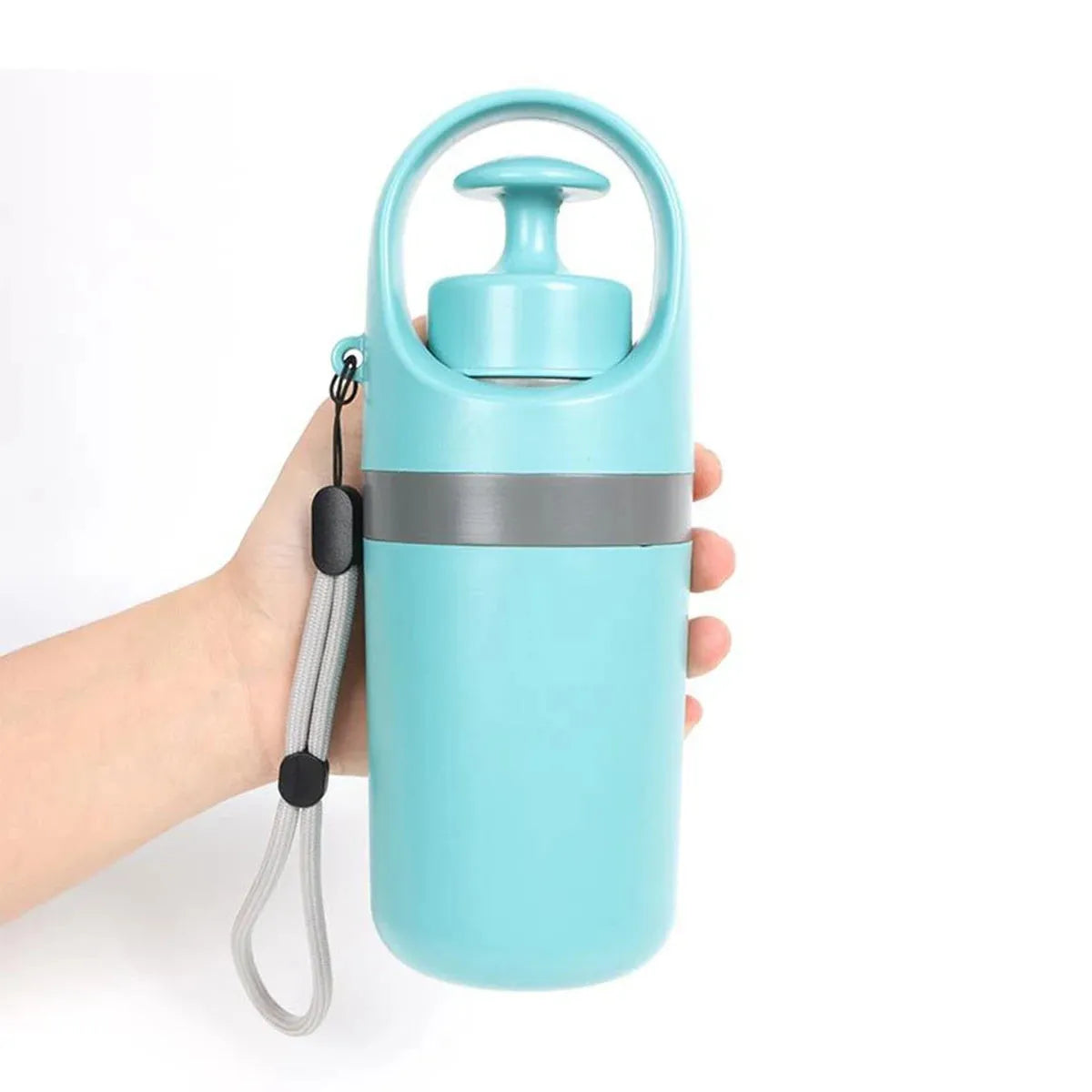 Blue dog pooper scooper with claw mechanism and bag dispenser on grass