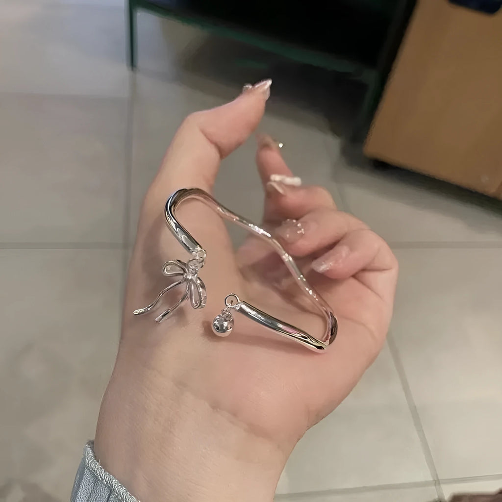 Silver adjustable bow bracelet with bowbell clasp on adjustable chain