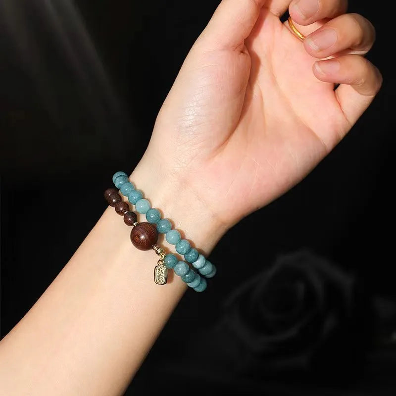 Natural stone blue beaded bracelet for women with sandalwood accents and Fu character motif