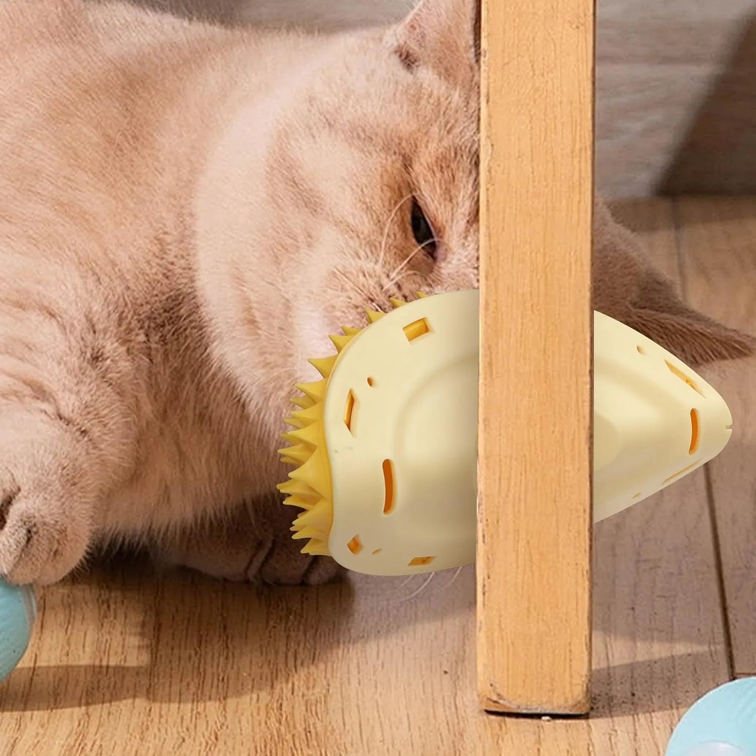 Yellow durian-shaped cat corner scratcher with cat face pattern and adhesive backing.