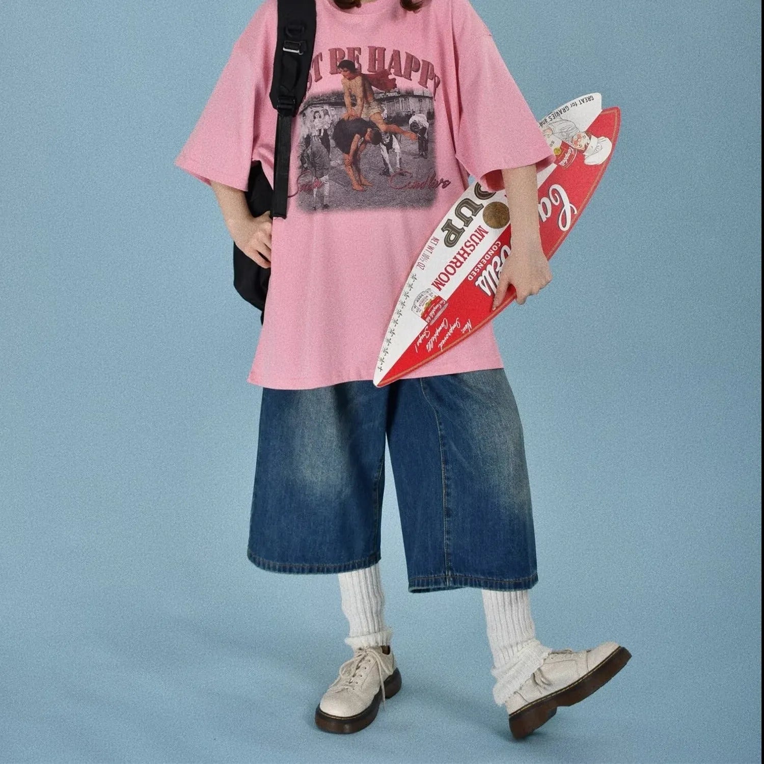 Men's loose straight-cut denim shorts in blue shown on a model, featuring a fifth-pants length.