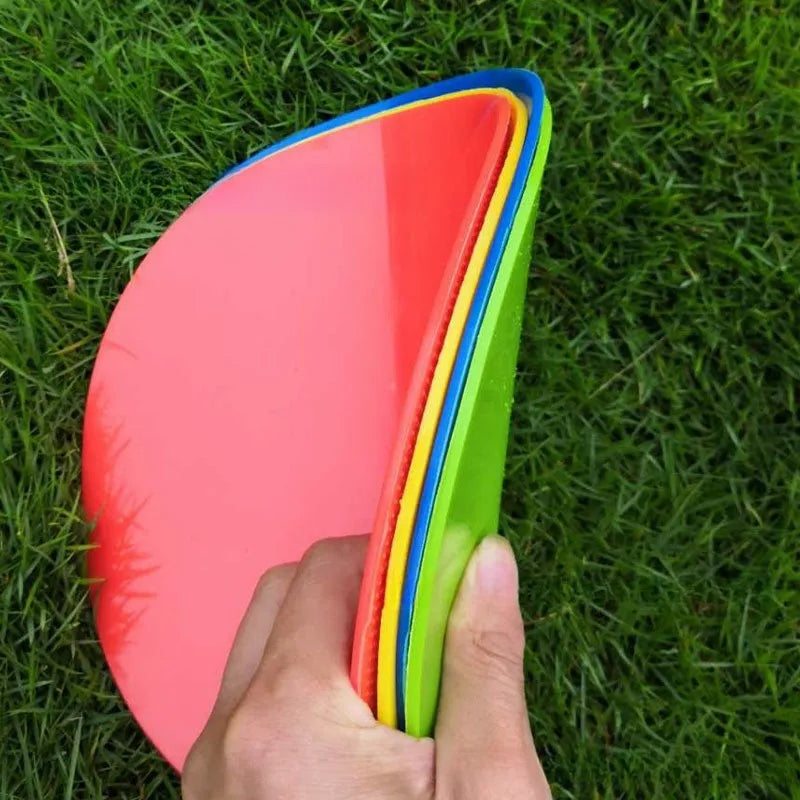 Flat circular yellow football training landmark pad on grass, 23cm diameter