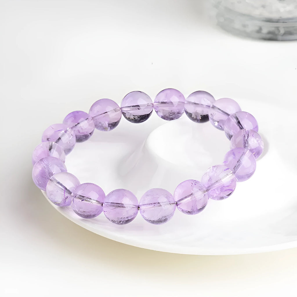 Lavender amethyst crystal bracelet with round beads showing water ripple pattern in light purple colour