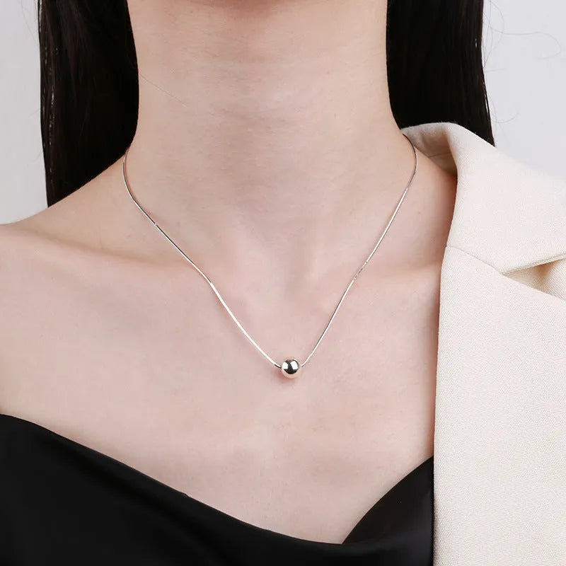 925 sterling silver clavicle chain necklace with round ball pendant on woman's neck