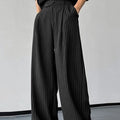 Men's black vertical striped pleated casual trousers showing elastic fabric and detailed sizing
