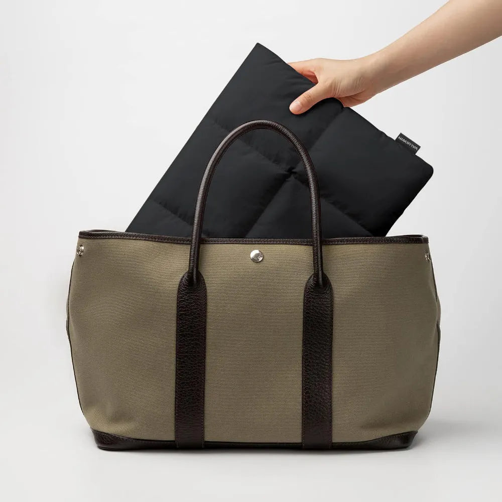 Soft fluffy laptop sleeve in black and khaki colours showing European American retro style design