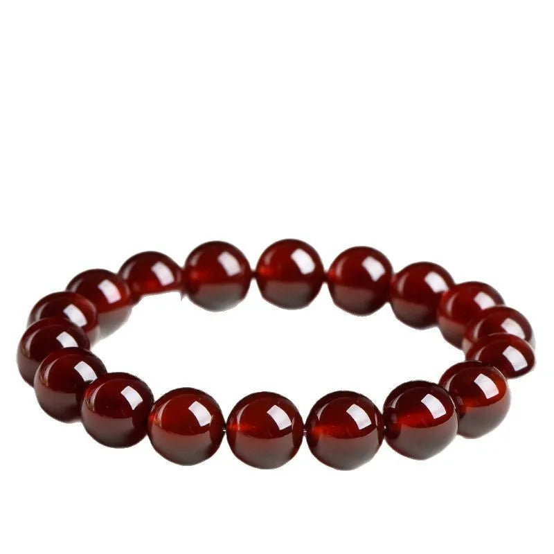 Natural orange red garnet ball bracelet with ruyi charm showing crystal construction and spherical gemstones