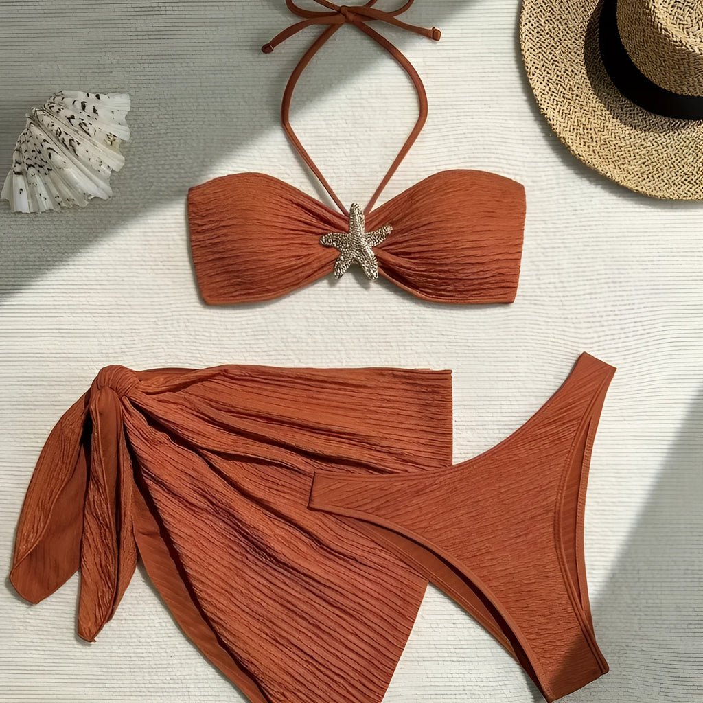Brown floral three-piece swimsuit set with tube top, pants, and skirt on a model